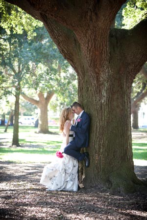 Loving married couple nuzzling at a park in Charleston, South Carolina