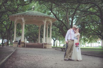 The bride and groom standing near the Gazebo at White Point Garden in Charleston, SC