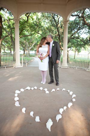 Charleston says love. A Married couple kiss in the gazebo on Charleston Battery