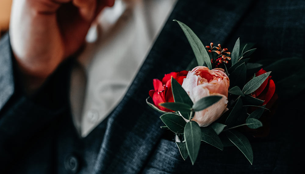 A groom adjusting his bowtie.