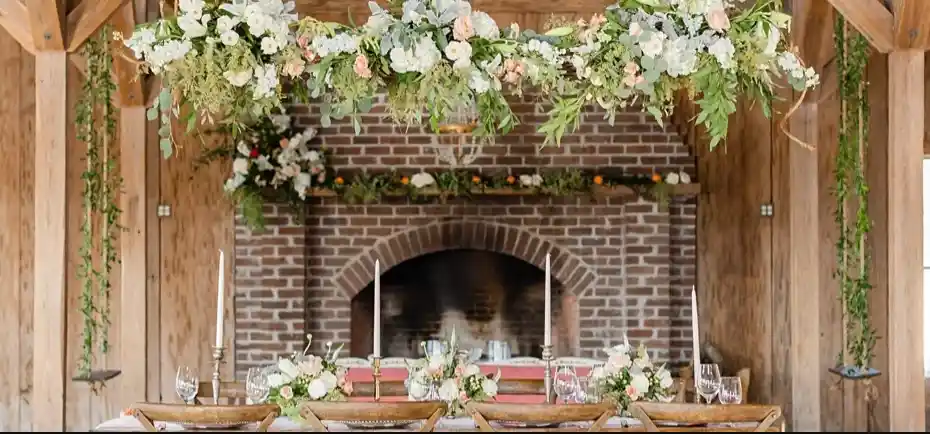 A barn wedding with wedding flowers decorating the space.